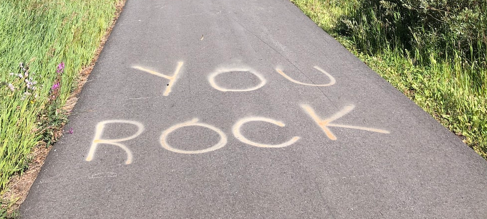 bike path with the words You Rock written in chalk