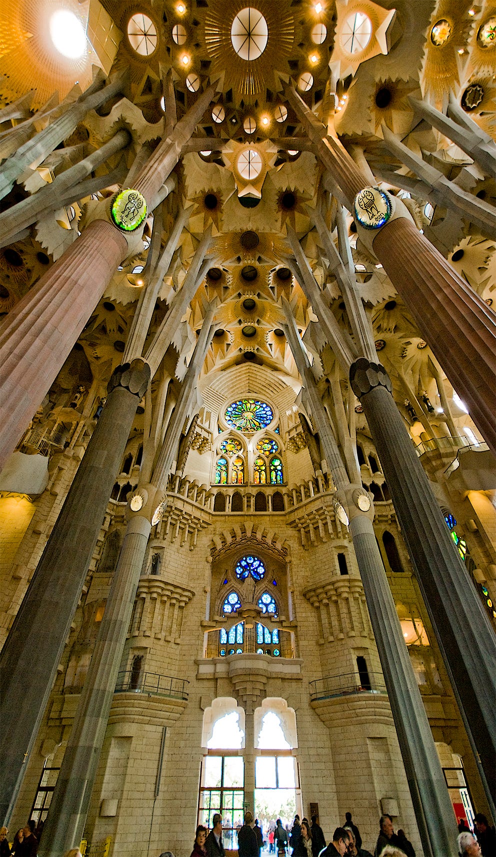 The inside of the Sagrada Família, complete with impressive stone structures and stained glass.