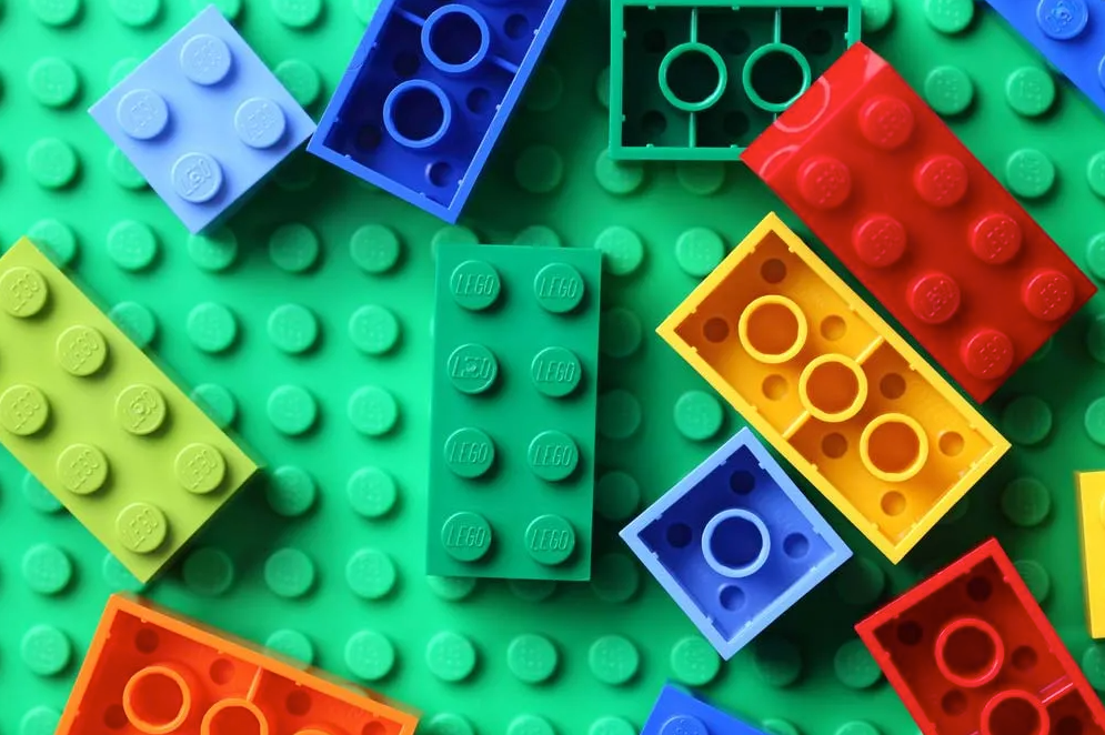 An image depicting LEGO blocks arranged to represent abstract concepts connected as single, reusable units within a framework.