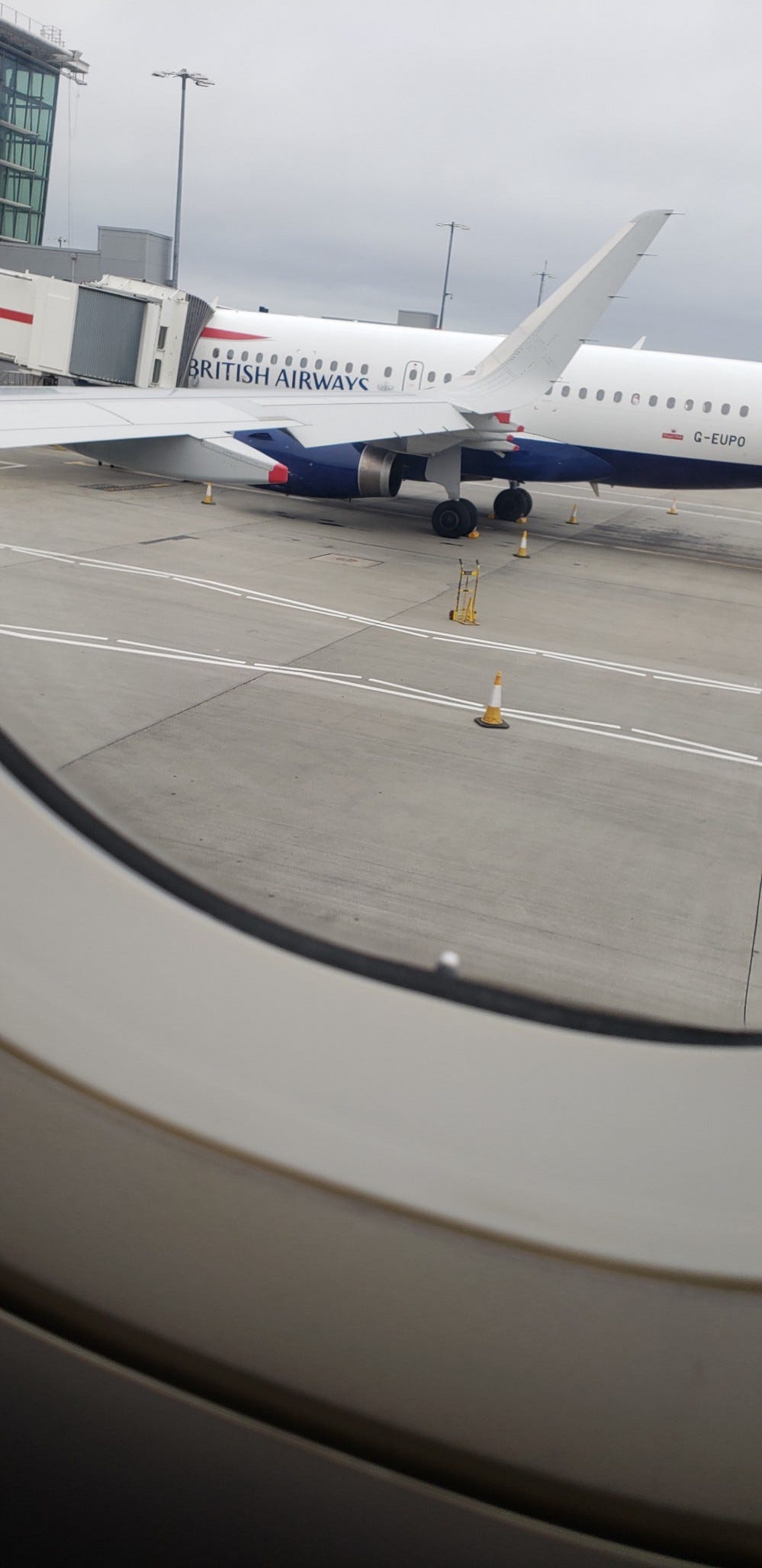Window view of a British Airways airplane on the runway at Heathrow Airport Termianl 5
