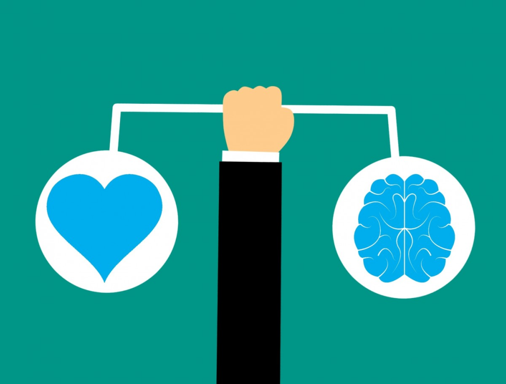 Illustration of an arm holding a scale, balanced by a brain and a heart