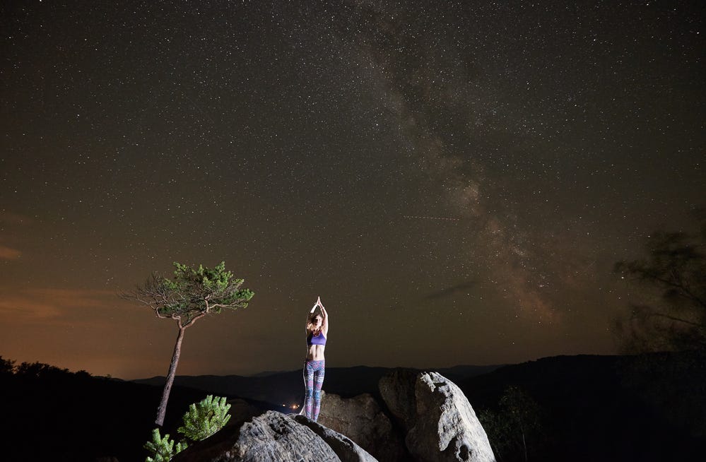 Girl in awe viewing the Magellanic Clouds and the Milky Way Galaxy at Joshua Tree.