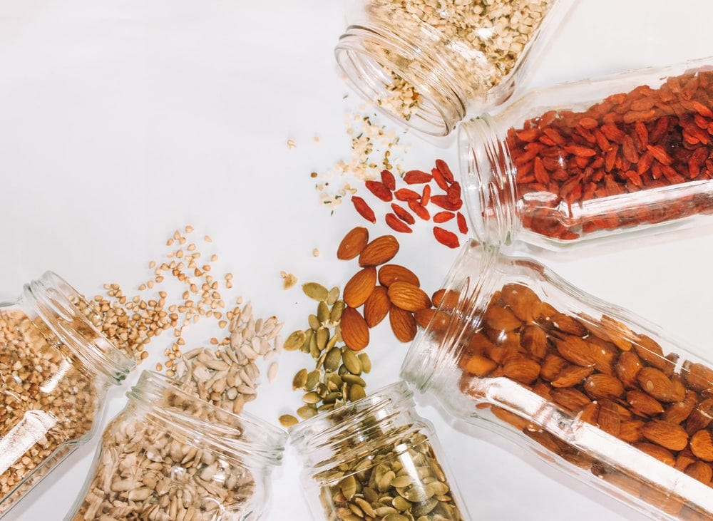 Nuts and seeds spilling out of their containers.