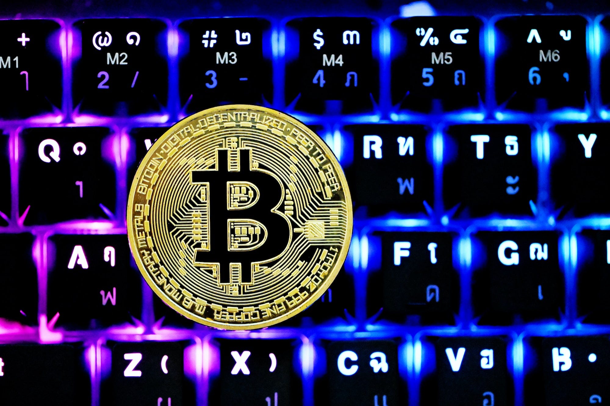 A single Bitcoin on top of the keyboard