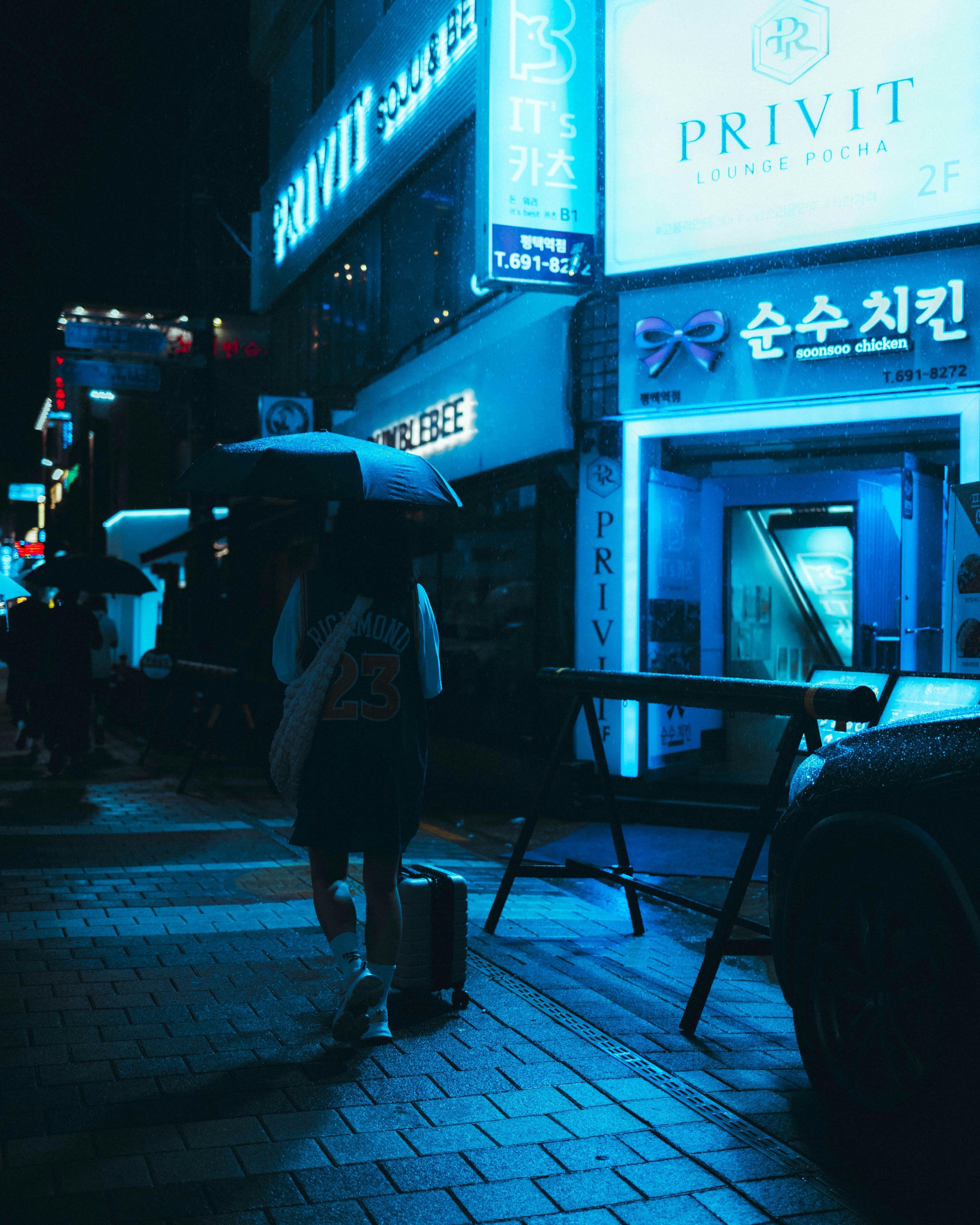 a person walking down a street holding an umbrella