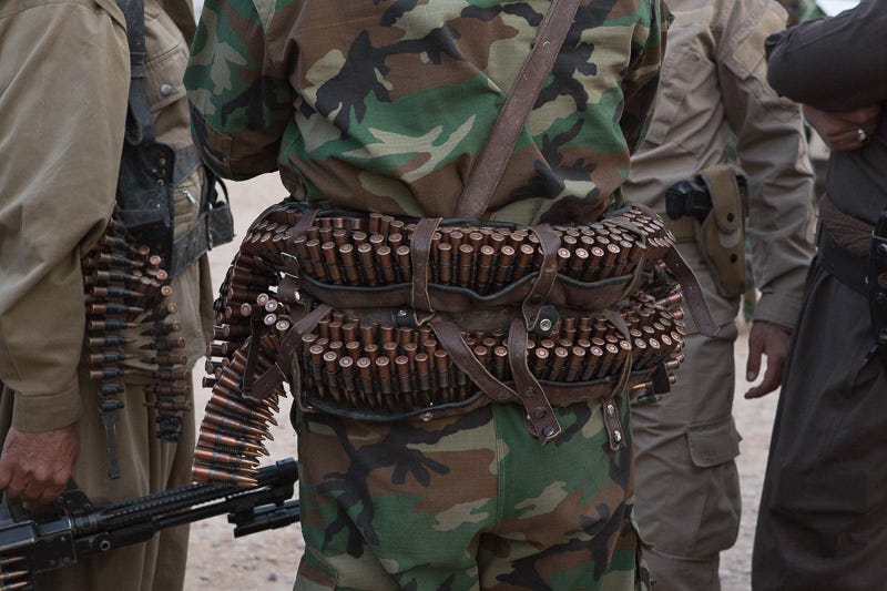 30/09/2015. Kirkuk, Iraq. A peshmerga fighter wearing a belt holding ammunition for a PKM machine gun is seen at the start point for an offensive against ISIS held villages to the west of Kirkuk, Iraq. Supported by coalition airstrikes around 3500 peshmerga of the Patriotic Union of Kurdistan (PUK) and the Kurdistan Democratic Party (KDP) engaged in a large offensive to push Islamic State militants out of villages to the west of Kirkuk. During previous offensives ISIS fighters withdrew after sustained coalition air support, but this time in many places militants stayed and fought. The day would see the coalition conduct around 50 airstrikes helping the joint peshmerga force to advance to within a few kilometres of the ISIS stronghold of Hawija and re-take around 17 villages. Around 20 peshmerga lost their lives to improvised explosive devices left by the Islamic State, reports suggest that between 40 and 150 militants were killed.