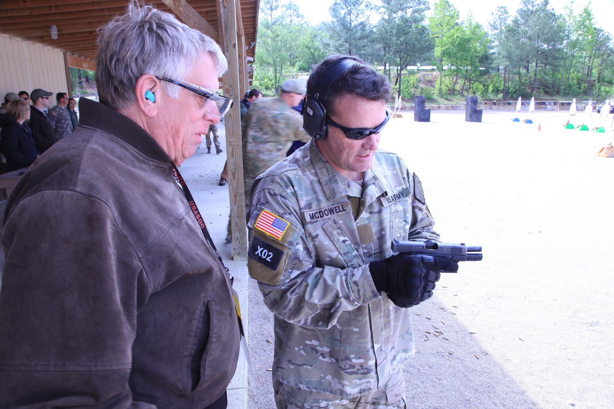 An Army special forces soldier shows a Glock to a civilian during a capabilities demonstration in 2012. Army photo