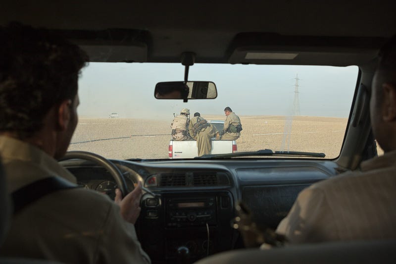 30/09/2015. Kirkuk, Iraq. Peshmerga fighters and volunteers move through no-man's land as they advance on villages held by the Islamic State west of Kirkuk, Iraq. Supported by coalition airstrikes around 3500 peshmerga of the Patriotic Union of Kurdistan (PUK) and the Kurdistan Democratic Party (KDP) engaged in a large offensive to push Islamic State militants out of villages to the west of Kirkuk. During previous offensives ISIS fighters withdrew after sustained coalition air support, but this time in many places militants stayed and fought. The day would see the coalition conduct around 50 airstrikes helping the joint peshmerga force to advance to within a few kilometres of the ISIS stronghold of Hawija and re-take around 17 villages. Around 20 peshmerga lost their lives to improvised explosive devices left by the Islamic State, reports suggest that between 40 and 150 militants were killed.