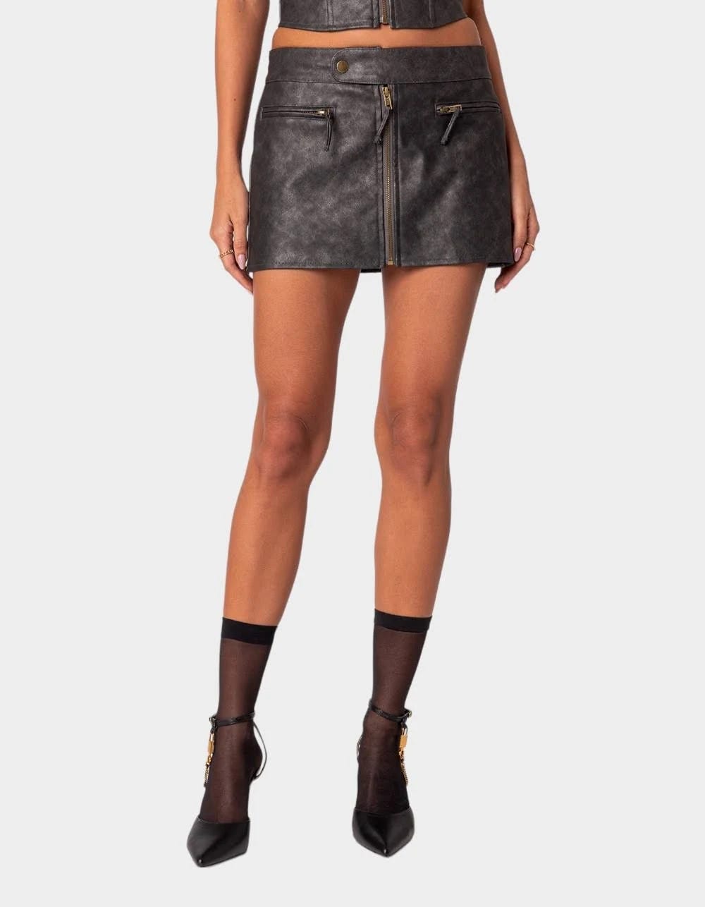 Classic Black Faux Leather Mini Skirt with Snap Buttons and Zip Pockets | Image