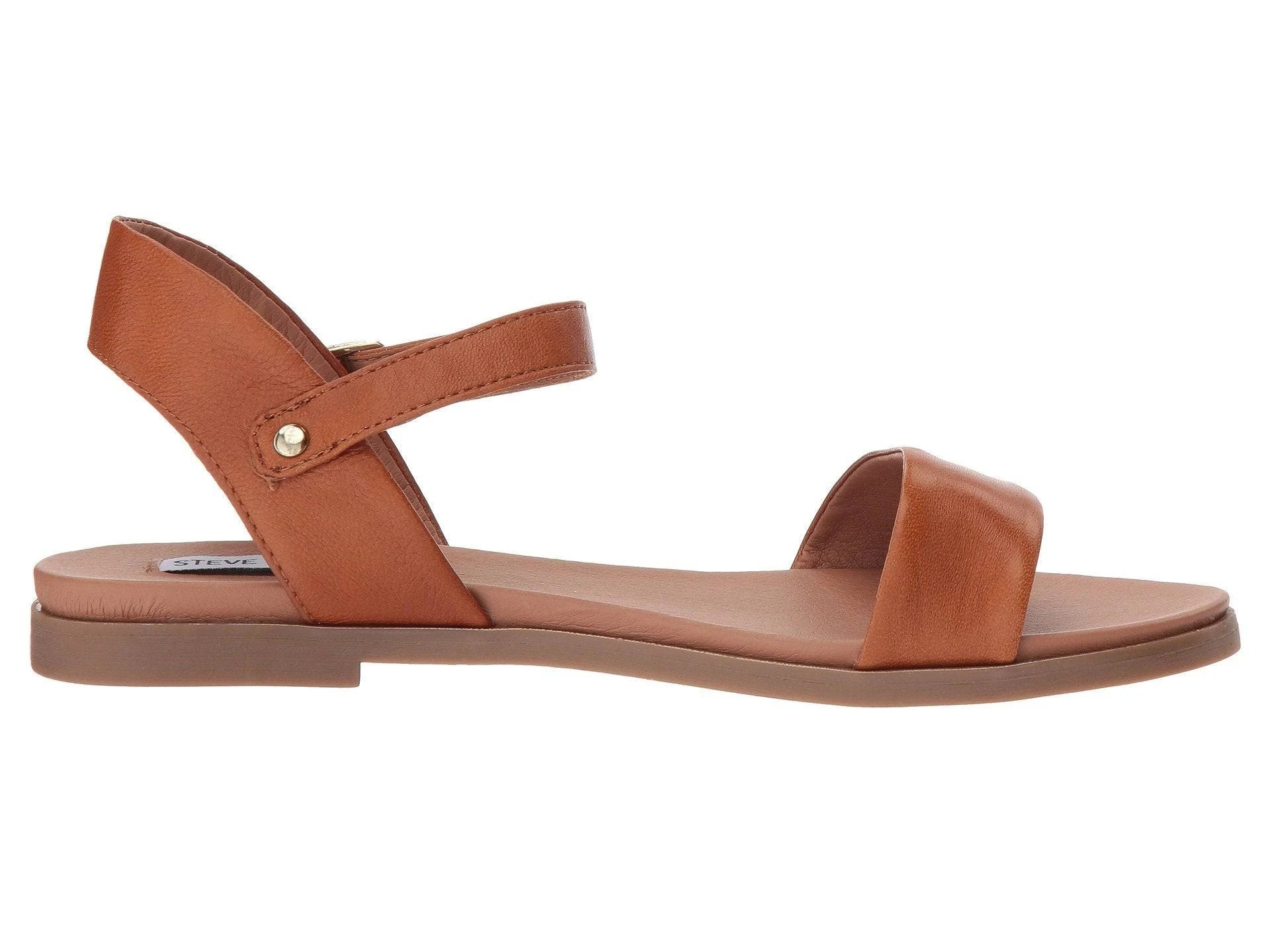Chic tan leather sandals with adjustable buckle closure and cushioned footbed | Image
