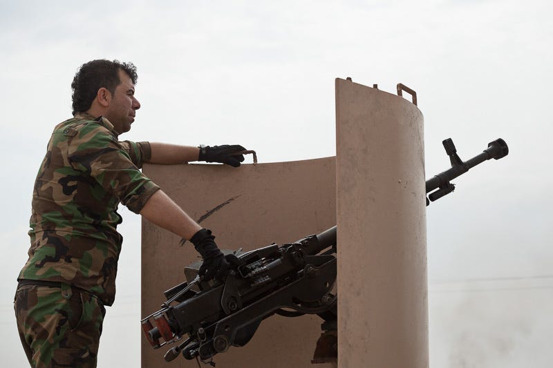 30/09/2015. Kirkuk, Iraq. A KDP peshmerga fighter watches towards the village of Mansuriya during an offensive to re-take several villages from the Islamic State west of Kirkuk, Iraq. Supported by coalition airstrikes around 3500 peshmerga of the Patriotic Union of Kurdistan (PUK) and the Kurdistan Democratic Party (KDP) engaged in a large offensive to push Islamic State militants out of villages to the west of Kirkuk. During previous offensives ISIS fighters withdrew after sustained coalition air support, but this time in many places militants stayed and fought. The day would see the coalition conduct around 50 airstrikes helping the joint peshmerga force to advance to within a few kilometres of the ISIS stronghold of Hawija and re-take around 17 villages. Around 20 peshmerga lost their lives to improvised explosive devices left by the Islamic State, reports suggest that between 40 and 150 militants were killed.