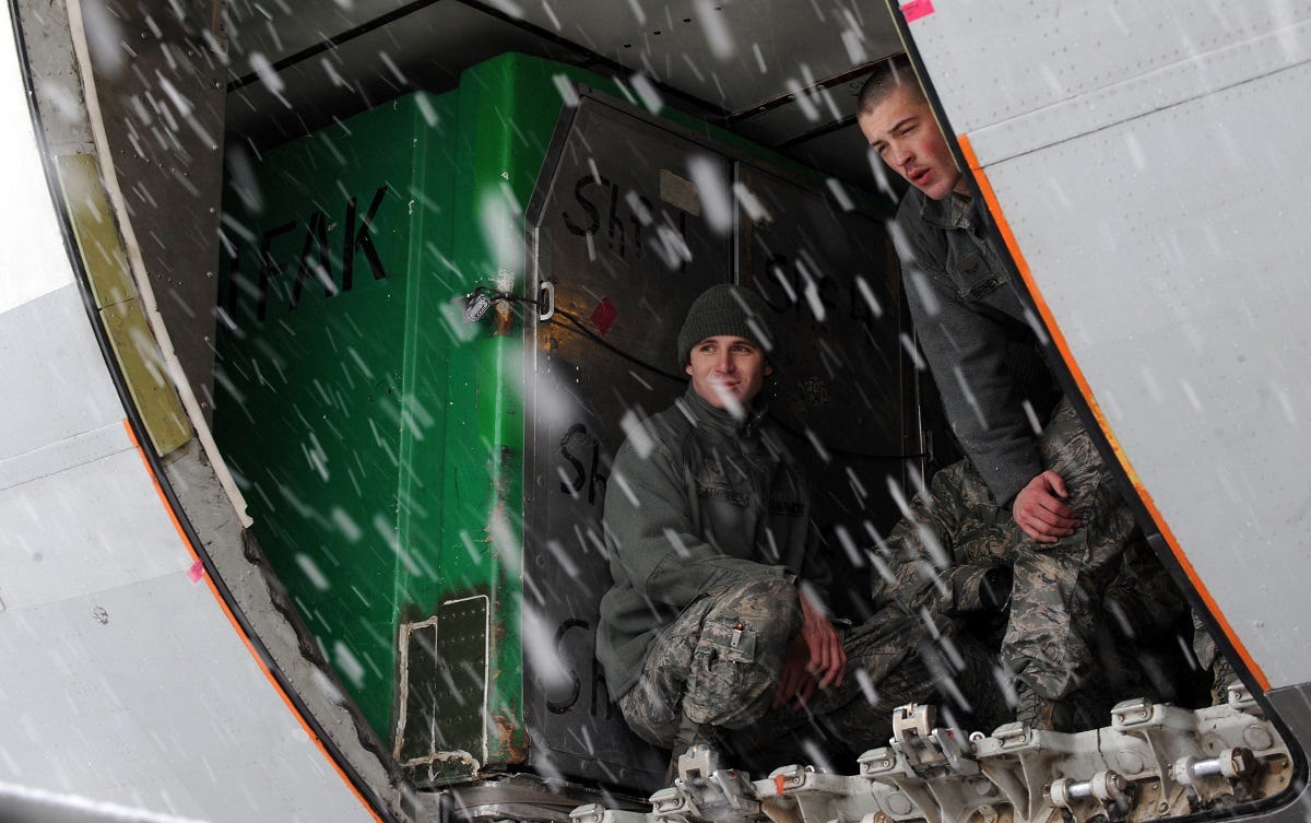 MOUNTAIN HOME AIR FORCE BASE, Idaho  Airmen from the 366th Fighter Wing take a break from loading baggage inside an aircraft, March 7. More than 400 Airmen from across the 366th Fighter Wing are deploying in support of Operation Enduring Freedom. Airmen in a variety of non-aviation roles are scheduled to conduct a wide range of tasks to ensure the success of providing critical combat power capabilities. (U.S. Air Force photo by Senior Airman Debbie Lockhart)