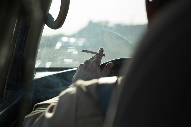 29/09/2015. Kirkuk, Iraq. Hadji Fazer, a volunteer peshmerga, smokes as he drives a 4x4 as he and his group of fighters move to front line positions ahead of a peshmerga offensive against ISIS held villages to the west of Kirkuk, Iraq. Supported by coalition airstrikes around 3500 peshmerga of the Patriotic Union of Kurdistan (PUK) and the Kurdistan Democratic Party (KDP) engaged in a large offensive to push Islamic State militants out of villages to the west of Kirkuk. During previous offensives ISIS fighters withdrew after sustained coalition air support, but this time in many places militants stayed and fought. The day would see the coalition conduct around 50 airstrikes helping the joint peshmerga force to advance to within a few kilometres of the ISIS stronghold of Hawija and re-take around 17 villages. Around 20 peshmerga lost their lives to improvised explosive devices left by the Islamic State, reports suggest that between 40 and 150 militants were killed.