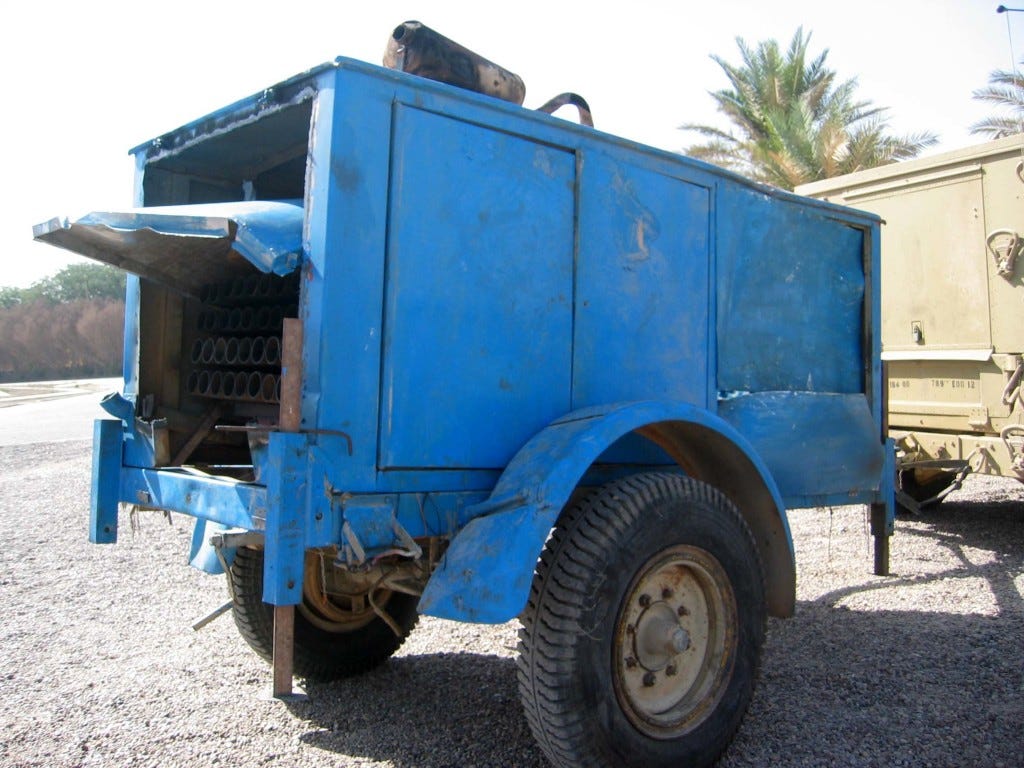 Above - A rocket launcher hidden inside a generator trailer captured by American troops in Iraq in 2003. Air Force photo At top - a U.S. Navy bomb tech carries a dud rocket out of an Iraqi police station in 2006. Pentagon photo