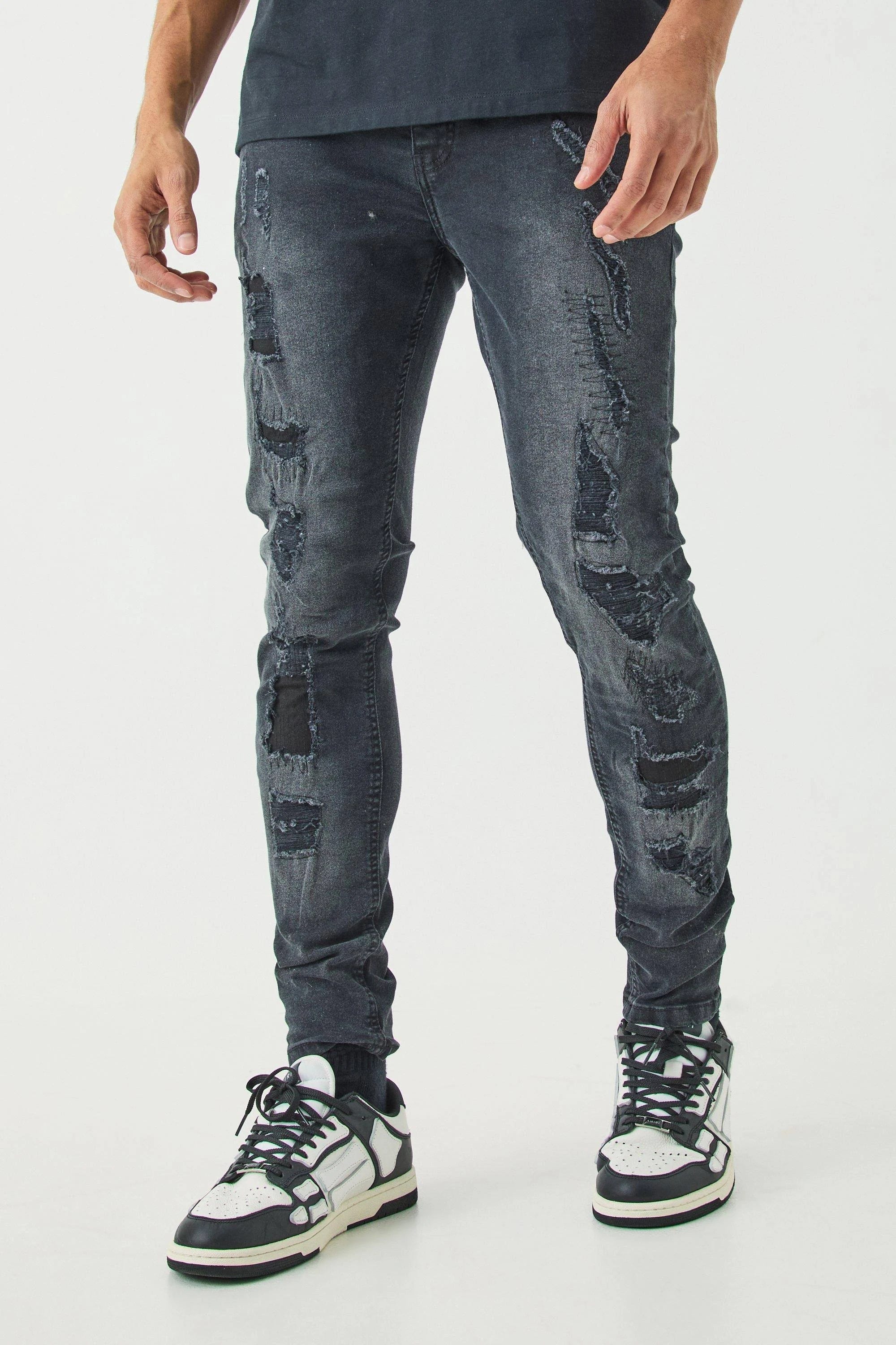Modern Black Skinny Jeans with All-Over Rips | Image