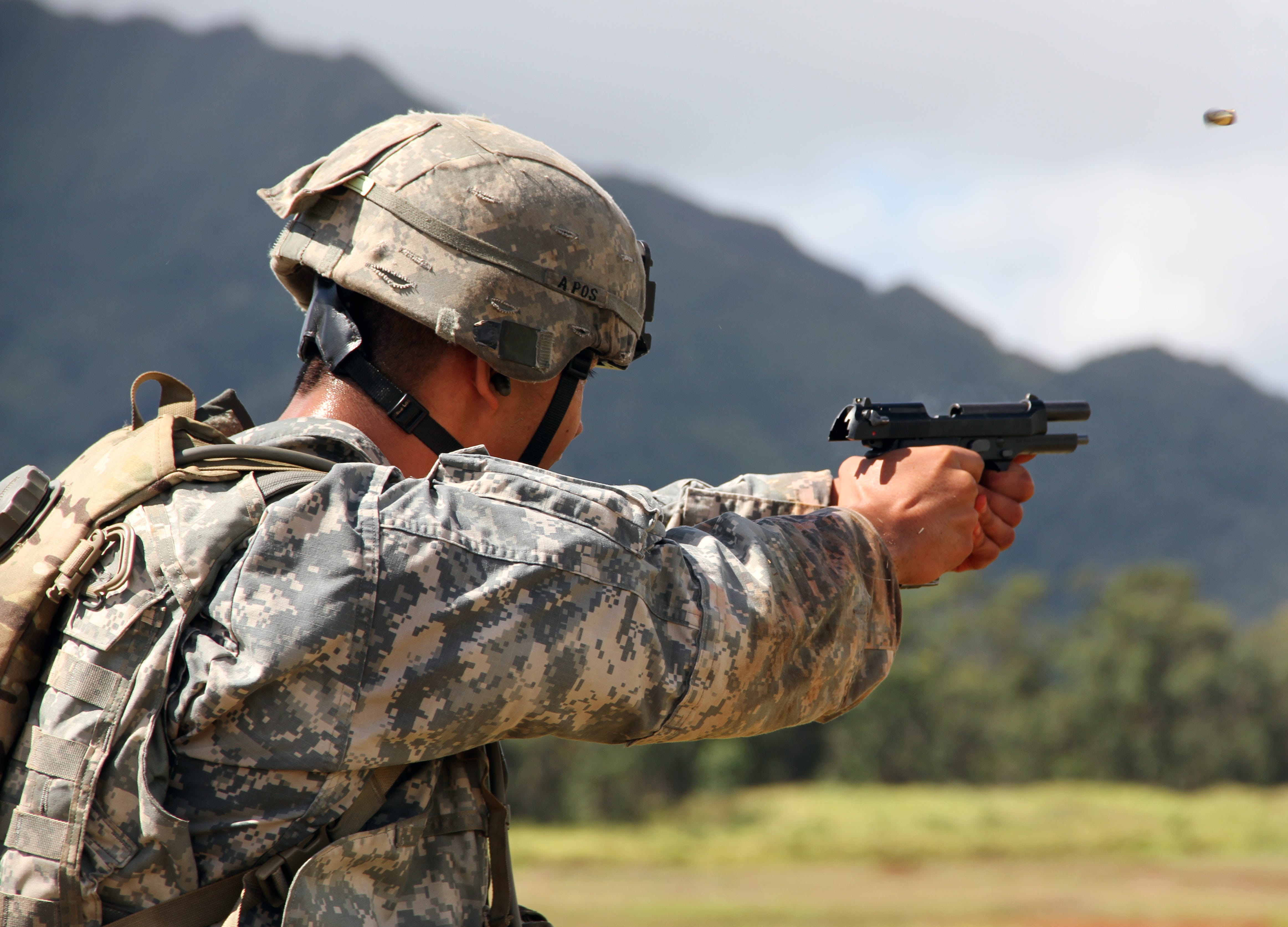 Above - a U.S. Army soldier shoots an M-9. At top - a Special Forces soldier takes part in a competition in Colombia with his Glock. Army photos