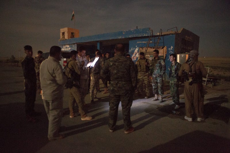 29/09/2015. Kirkuk, Iraq. Peshmerga fighters affiliated to the Kurdish Democratic Party (KDP), listen to a briefing from their captain ahead of a large offensive to take back Islamic State held villages west of Kirkuk, Iraq. Supported by coalition airstrikes around 3500 peshmerga of the Patriotic Union of Kurdistan (PUK) and the Kurdistan Democratic Party (KDP) engaged in a large offensive to push Islamic State militants out of villages to the west of Kirkuk. During previous offensives ISIS fighters withdrew after sustained coalition air support, but this time in many places militants stayed and fought. The day would see the coalition conduct around 50 airstrikes helping the joint peshmerga force to advance to within a few kilometres of the ISIS stronghold of Hawija and re-take around 17 villages. Around 20 peshmerga lost their lives to improvised explosive devices left by the Islamic State, reports suggest that between 40 and 150 militants were killed.