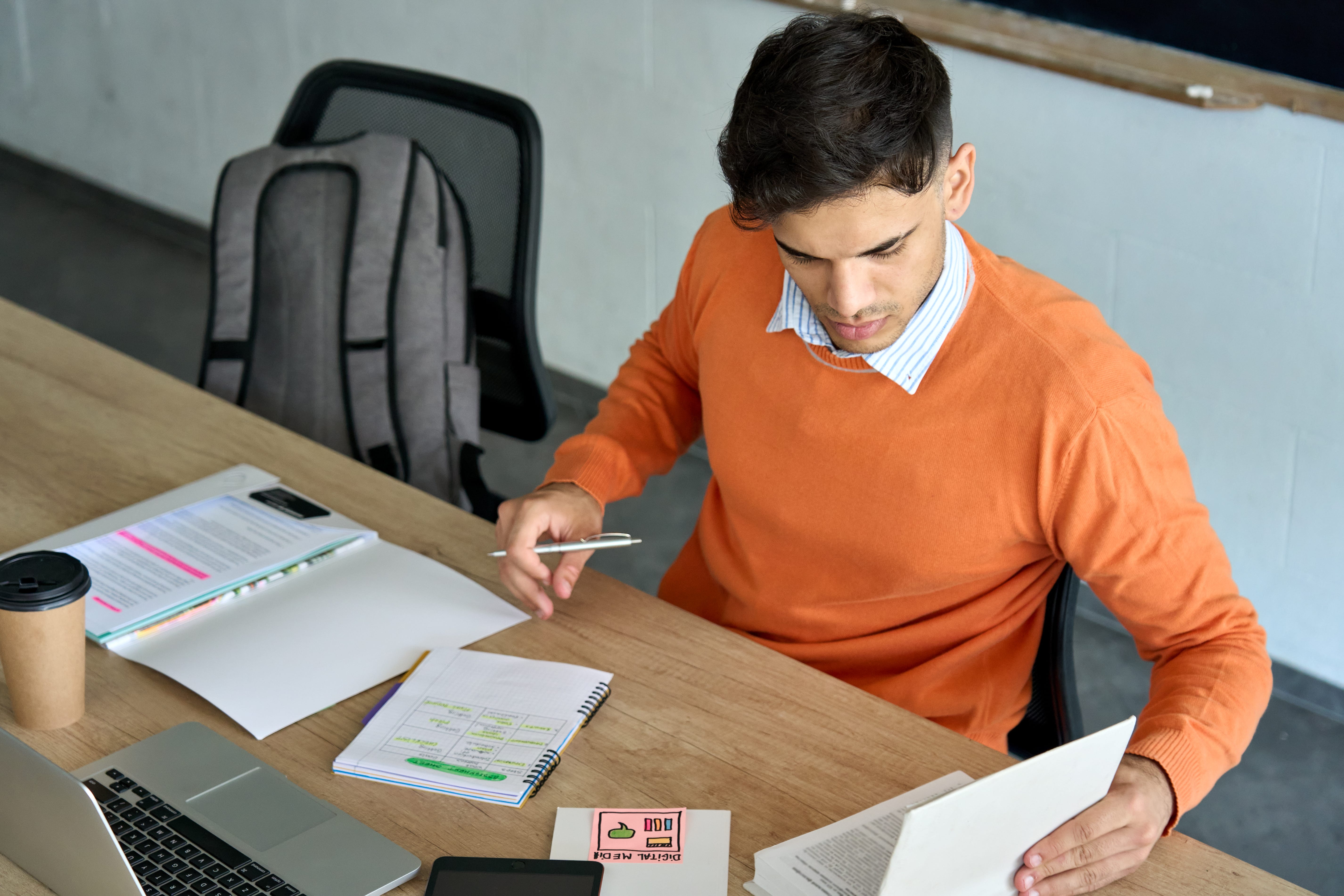 A normal day at Board of UX. A BUX Researcher at his desk working through User Research process.