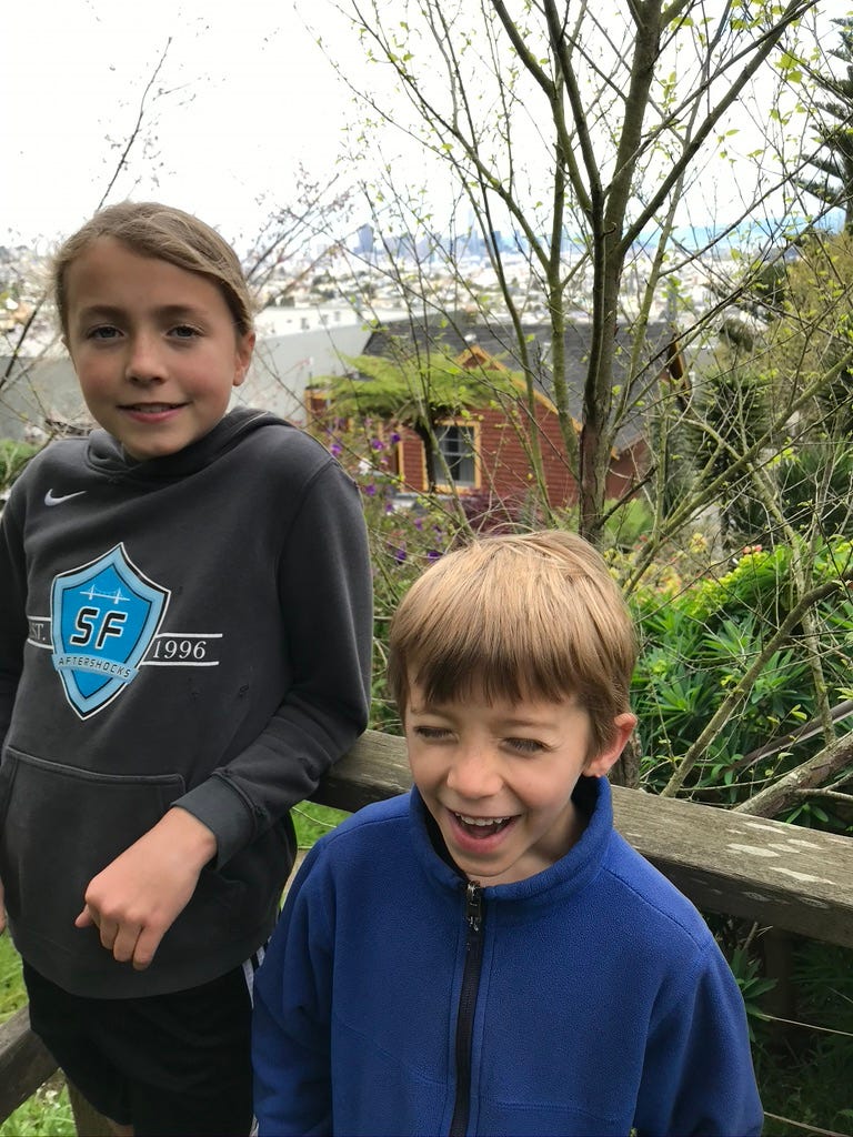 Kids in front of view of city on Harry Street.