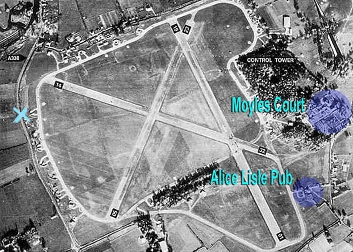 Aerial view of the historic Ibsley RAF airfield, showing three main intersecting runways and many fighter planes lined up on a ring road.
